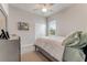 Cozy bedroom with ceiling fan, carpeted floor and large window at 2824 S Asciano Ct, New Smyrna Beach, FL 32168