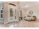 Bright entryway with wood-look floors, featuring a sitting area and white French doors at 2824 S Asciano Ct, New Smyrna Beach, FL 32168