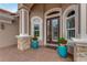 Elegant entryway with double doors, stone accents, and lush planters at 2824 S Asciano Ct, New Smyrna Beach, FL 32168