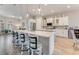 Kitchen island with seating, white cabinets, and stainless steel appliances at 2824 S Asciano Ct, New Smyrna Beach, FL 32168