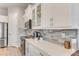 Modern kitchen with white cabinets, quartz countertops, and tile backsplash at 2824 S Asciano Ct, New Smyrna Beach, FL 32168