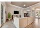 Bright living room with wood floors, tray ceiling, and adjacent dining area with lots of natural light at 2824 S Asciano Ct, New Smyrna Beach, FL 32168