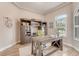 Cozy office space featuring a built-in desk, custom shelves, and abundant natural light at 2824 S Asciano Ct, New Smyrna Beach, FL 32168