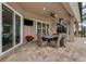 Covered patio with outdoor dining set and views of the pool at 2824 S Asciano Ct, New Smyrna Beach, FL 32168