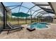 Relaxing pool and spa with patio furniture under a covered patio at 2824 S Asciano Ct, New Smyrna Beach, FL 32168