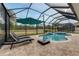 Screened pool area with patio furniture and scenic golf course views at 2824 S Asciano Ct, New Smyrna Beach, FL 32168