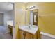 Bathroom with single sink vanity and yellow walls at 2916 Duchess Oak Ct, St Cloud, FL 34769