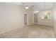 Living room with neutral walls, carpet, and access to other rooms at 2916 Duchess Oak Ct, St Cloud, FL 34769