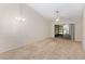 Spacious living room with vaulted ceiling, carpeting, and sliding doors to screened porch at 2916 Duchess Oak Ct, St Cloud, FL 34769