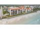 Aerial view of beachfront condo building with ocean and surrounding neighborhood at 3001 S Atlantic Ave # 501, New Smyrna Beach, FL 32169