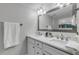 Double vanity bathroom with a large mirror and walk-in shower at 3001 S Atlantic Ave # 501, New Smyrna Beach, FL 32169