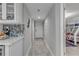 Hallway with light gray walls and wood-look tile flooring, leading to bedrooms at 3001 S Atlantic Ave # 501, New Smyrna Beach, FL 32169