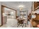 Dining room with chandelier, table set for four, and pool view at 3039 Tamarind Dr, Edgewater, FL 32141