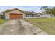 One-story home with wood garage door and screened porch at 3039 Tamarind Dr, Edgewater, FL 32141