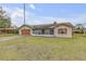 One-story home with wood garage door and screened porch at 3039 Tamarind Dr, Edgewater, FL 32141