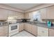 Kitchen corner with white appliances and gray countertops at 3039 Tamarind Dr, Edgewater, FL 32141