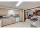 Kitchen with view into dining area, white appliances, and wood cabinets at 3039 Tamarind Dr, Edgewater, FL 32141