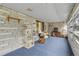 Relaxing screened porch with brick walls, rocking chair, and cat tree at 3039 Tamarind Dr, Edgewater, FL 32141