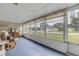 Bright sunroom with rocking chair and view of the street at 3039 Tamarind Dr, Edgewater, FL 32141