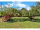 Landscaped backyard with tropical plants at 3112 Needle Palm Dr, Edgewater, FL 32141