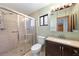 Updated bathroom with a walk-in shower and dark vanity at 3112 Needle Palm Dr, Edgewater, FL 32141