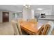 Bright dining area with wood table and chairs, near kitchen at 3112 Needle Palm Dr, Edgewater, FL 32141