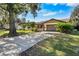 Attractive single-story home with a long driveway and lush landscaping at 3112 Needle Palm Dr, Edgewater, FL 32141