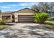 House exterior with a brown garage door and driveway at 3112 Needle Palm Dr, Edgewater, FL 32141