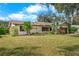 Ranch home with a large grassy front yard at 3112 Needle Palm Dr, Edgewater, FL 32141