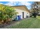 Rear view of house showing exterior features, landscaping, and storage area at 3112 Needle Palm Dr, Edgewater, FL 32141