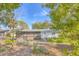 Backyard view of house with screened enclosure at 3120 Pine Tree Dr, Edgewater, FL 32141