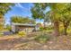 View of the home's back and partially fenced backyard at 3120 Pine Tree Dr, Edgewater, FL 32141