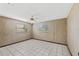 Well-lit bedroom with tiled floors and window blinds at 3120 Pine Tree Dr, Edgewater, FL 32141