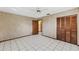 Bedroom with wood-paneled closets and tiled floors at 3120 Pine Tree Dr, Edgewater, FL 32141