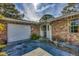 Brick home's front entrance with a white door and garage at 3120 Pine Tree Dr, Edgewater, FL 32141