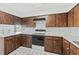 Wood kitchen cabinets and appliances, with a window at 3120 Pine Tree Dr, Edgewater, FL 32141