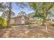 Brick house with side yard and mature trees at 3120 Pine Tree Dr, Edgewater, FL 32141