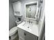 Updated bathroom with white vanity, new fixtures, and storage at 315 N Causeway # 304, New Smyrna Beach, FL 32169