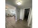 Bright hallway with wood-look floors leading to living room and bedrooms at 315 N Causeway # 304, New Smyrna Beach, FL 32169