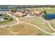 Aerial view of community clubhouse, golf course, and lake at 3203 Monaco Blvd, New Smyrna Beach, FL 32168