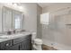 Bathroom with granite countertop, dark vanity, and shower at 3203 Monaco Blvd, New Smyrna Beach, FL 32168