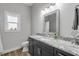 Bathroom with granite countertop, dark vanity, and shower at 3203 Monaco Blvd, New Smyrna Beach, FL 32168