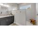 Modern bathroom with walk-in shower, granite vanity, and dark cabinetry at 3203 Monaco Blvd, New Smyrna Beach, FL 32168