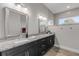 Double vanity bathroom with granite countertops and dark wood cabinets at 3203 Monaco Blvd, New Smyrna Beach, FL 32168