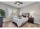 Bedroom with gray headboard, wood flooring, and ceiling fan at 3203 Monaco Blvd, New Smyrna Beach, FL 32168