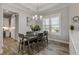 Dining room with dark wood table, gray chairs, and a view into the kitchen at 3203 Monaco Blvd, New Smyrna Beach, FL 32168