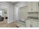 Bright laundry room, featuring modern washer and dryer, ample cabinetry, and granite countertop at 3203 Monaco Blvd, New Smyrna Beach, FL 32168