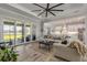 Living room with large sectional sofa and sliding doors leading to the backyard at 3203 Monaco Blvd, New Smyrna Beach, FL 32168