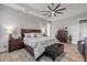 Main bedroom with wood flooring, ceiling fan, and dark wood furniture at 3203 Monaco Blvd, New Smyrna Beach, FL 32168