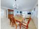 Light and airy dining area with wood table and chairs at 325 Causeway # E 203, New Smyrna Beach, FL 32169